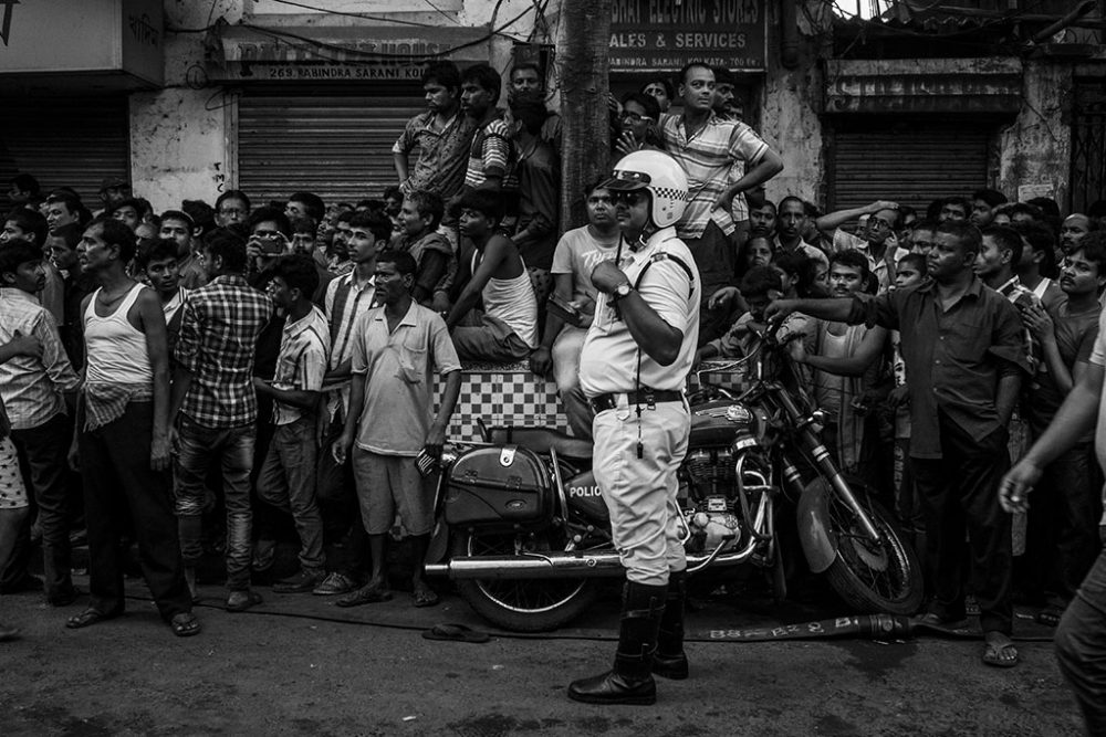 Kolkata, India- 31st March, 2016 . People gathered in the footpath to realise the enormity of the devastation.