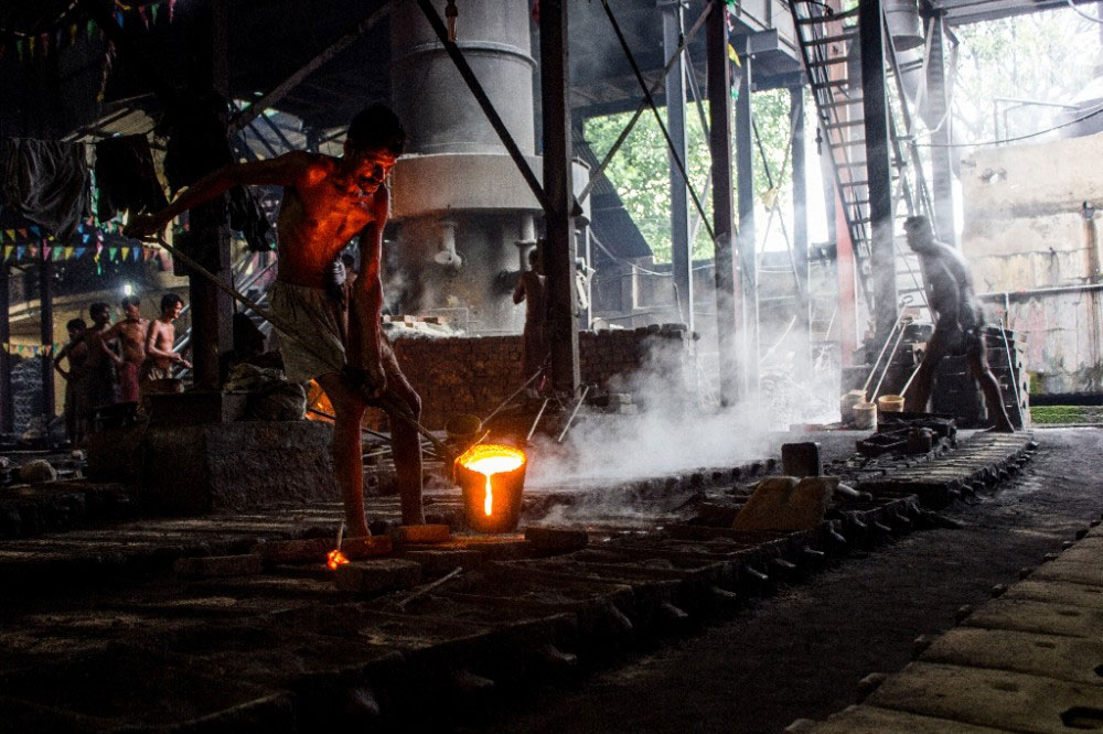 Kolkata,India-July 2015.Pouring hot iron in molds