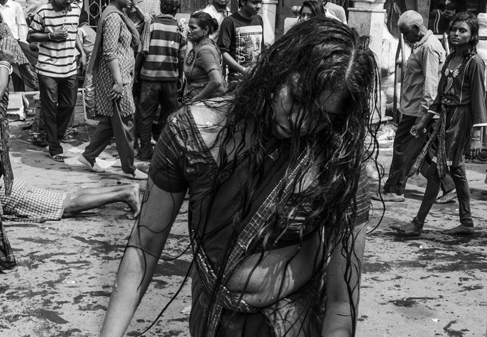 Howrah, India, February 2016, A woman 'possessed by demons' on the streets towards the temples