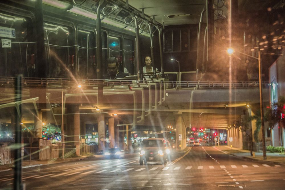 Honolulu, Hawaii - August, 2016. After 9 pm the whole city become calm and quiet. People usually are don't seen in the streets, the buses usually remain empty. I manage to relate these two cases and combine to a glass reflection on the bus.