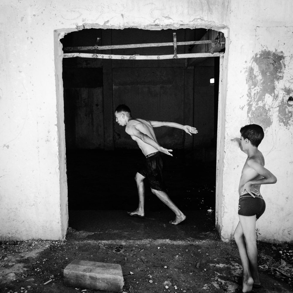 Young boys jumping in the bassin of the water tower,Mascara,July,25th,2016.